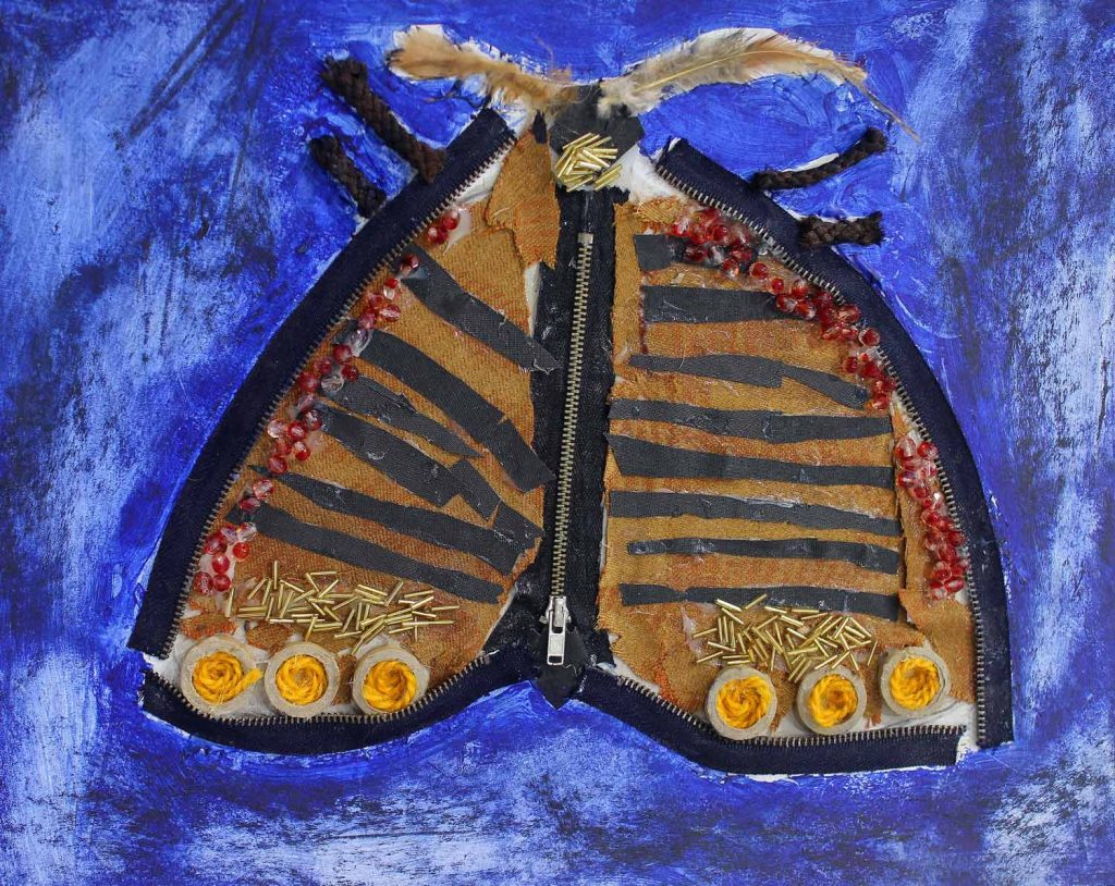 Student artwork of brown moth made from materials and zippers