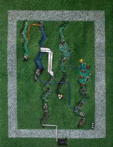 Artificial grass, paint, circuit boards and electrical wire assemblage by John Robinson, Year 12 Student artwork of circuit boards