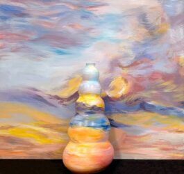 Student artwork of a painting background and ceramic vase