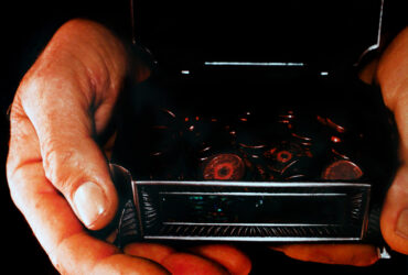 Digital photography with acetate filter by Hannah Biggins, Year 12, The Hamilton and Alexandra College Student artwork of hands holding coins