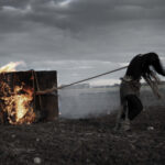 Student artwork of a girl pulling a box on fire