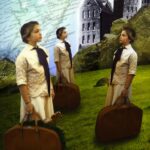 Student artwork of girls with suitcases