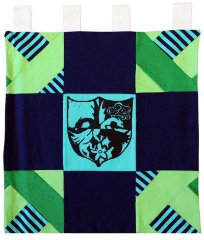Lino cut print on patchwork Fabric by Elly Chen, Year 8, St Catherine’s School Student artwork of a coat of arms
