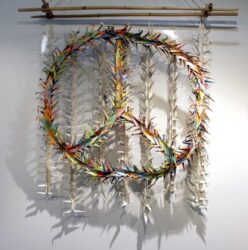 Student artwork of a peace sign made of paper cranes