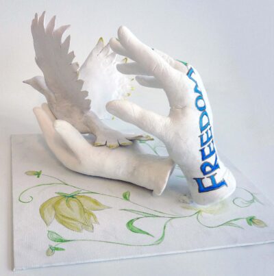 Student artwork of plaster hands and a dove