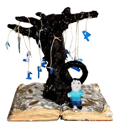 Student sculpture of a tree growing out of a book with a person