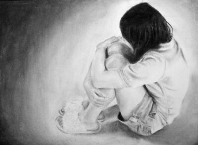 Student artwork of a crouched figure hugging her knees