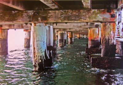 Student artwork photograph of pillars under a bridge rising out of the water