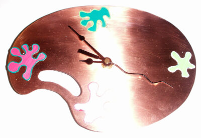 Student artwork of a metal clock in the shape of a palette
