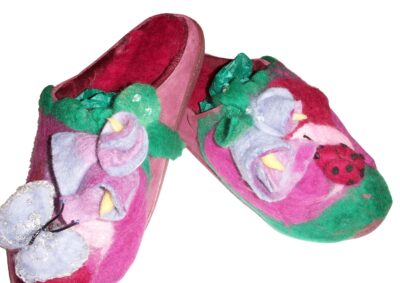 Student artwork of felt slippers with a garden motif