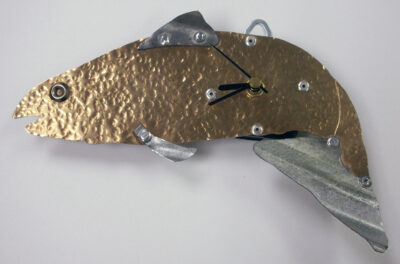 Student artwork of a metal clock in the shape of a fish
