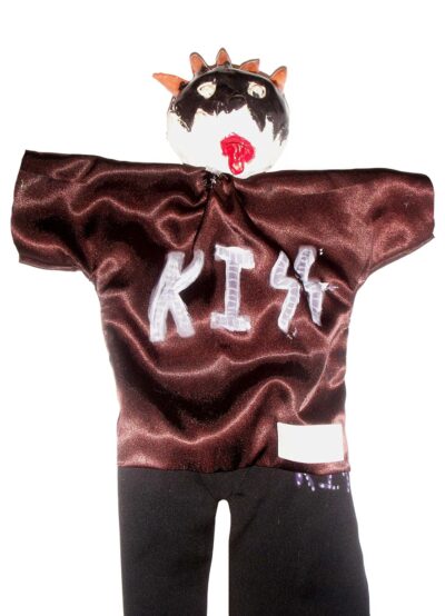 Ceramic and fabric by Andy Alesi, Grade 6, Melbourne Montessori School Student artwork of a puppet wearing a KISS print top