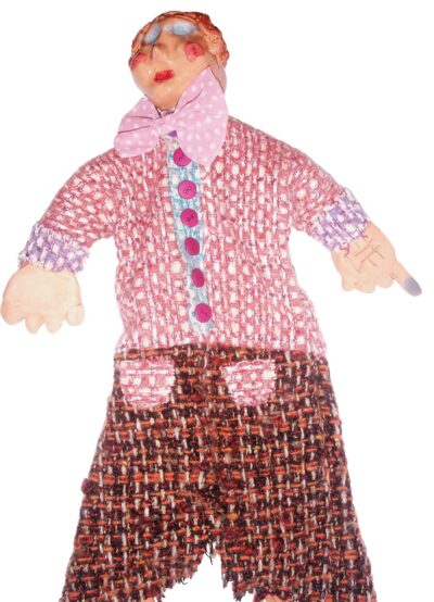 Ceramic and fabric by Nick Lowe, Grade 5, Melbourne Montessori School Student artwork of a puppet wearing a pink bow tie