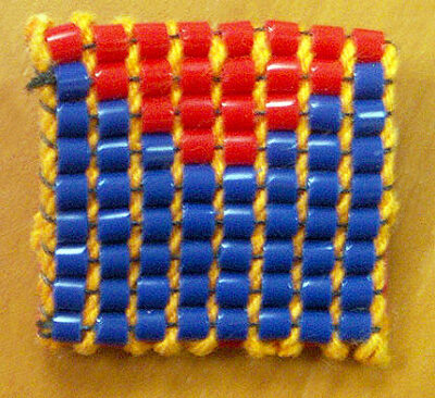 Woven wool and beads by Alexander Brooke, Year 3, Scotch College Student artwork of a Melbourne football flag sculpture made of beads