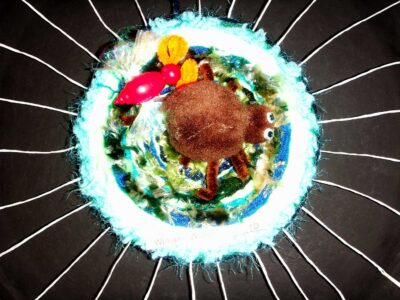 Woven fibres on pizza tray by William Wilson, Year 1, Scotch College Student artwork of a spiderweb sculpture