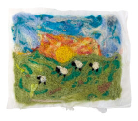 Student artwork of a felt scenery with sheep
